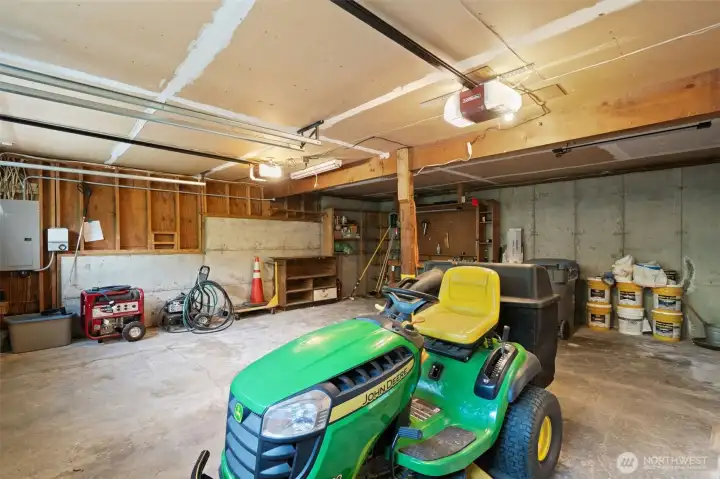 Attached two car garage. Like new John Deere riding mower, generator, and pressure washer all convey! New electrical panel in 2023. Attached two car garage. Like new John Deere riding mower, generator, and pressure washer all convey! New electrical panel in 2023.