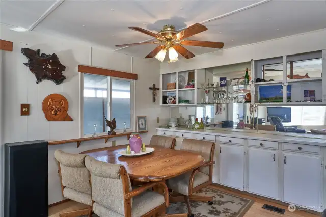 Formal dining room with built in white mirrored cabinets.