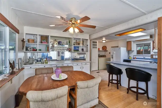 Open concept dining room open to breakfast bar and kitchen.