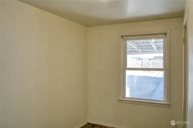 Bedroom 1 with view of the backyard