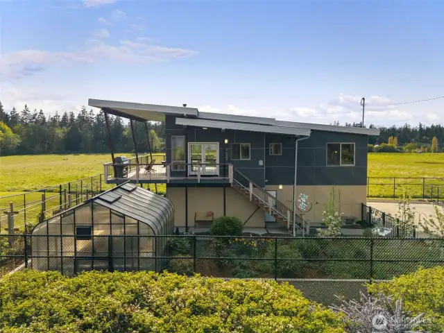 Modern deck and garden layout offer beauty and utility in a peaceful setting.