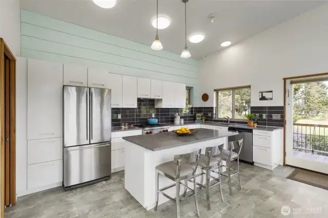 Light-filled living and dining area with expansive windows framing peaceful natural views.