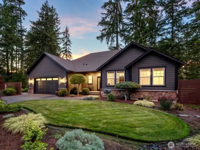 Twilight street view -- beautifully landscaped with a sprinkler system.