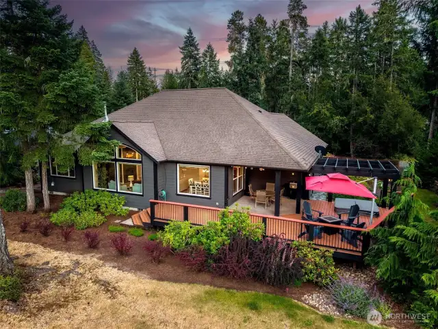 Twilight aerial view of the backyard and outdoor spaces.