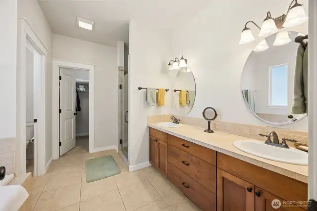 5-Piece primary bath is fully tiled with a deep soaking tub.