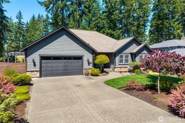 Street view showing aggregate driveway and walkway.