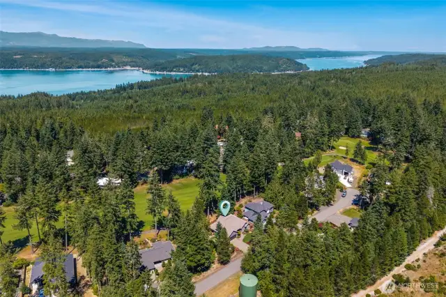 Aerial view of home showing proximity to Hood Canal and Olympic Peninsula recreation.
