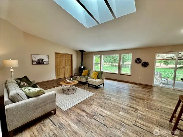 From entry to vaulted great room with skylights and sider to fenced rear yard. Wood stove perfect for keeping things cozy. Large slider leads to fully fenced rear yard.