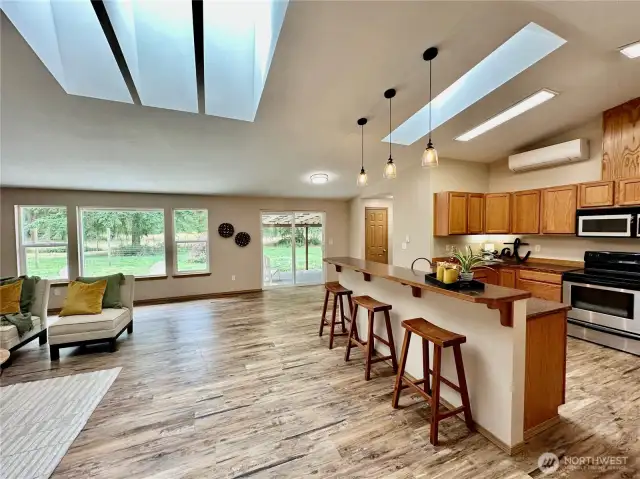 Kitchen to the right with bar area and room for table and chairs. Ductless mini split offers AC in the summer.