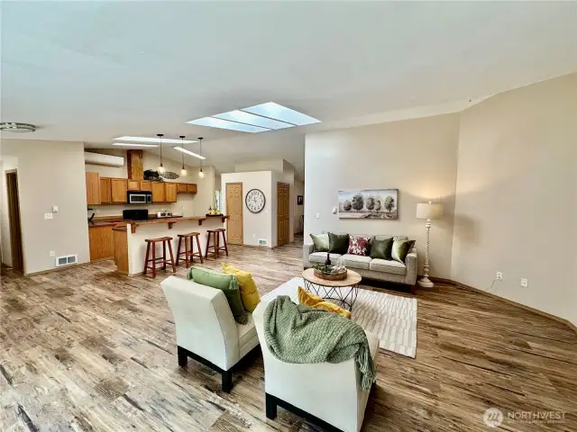 Looking from great room towards kitchen. Skylights in both living and kitchen area.