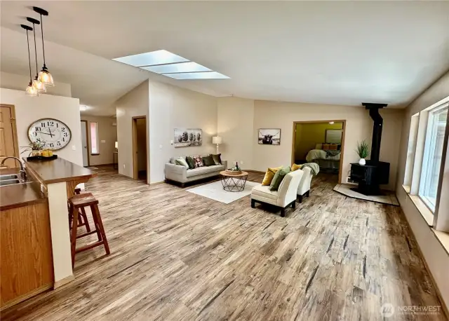 Great room offers wood stove, double doors lead to large primary suite.
