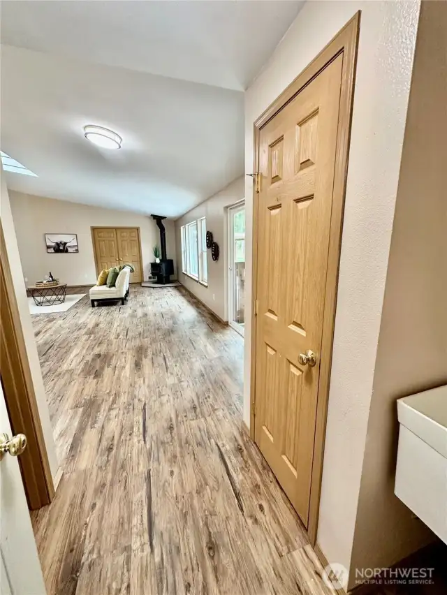 Looking from garage entrance to great room.  Toilet room to the left and laundry sink to the right.