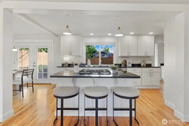 Kitchen extends beyond to the right where there's an oven/microwave wall, the refrigerator, a coffee/dry bar and  access to the bonus room via a coffee bar/dry bar.