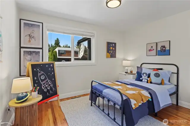 Second bedroom on the main floor. Custom built-in closet system with a drawer bank, hanging and shelves.