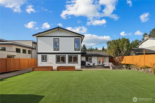 Massive level turf backyard. Raised planters have drip irrigation and both side yards are generously sized. There are storage closets on the right for lawn/garden equipment and a bike shed on the left with room for additional storage if desired.