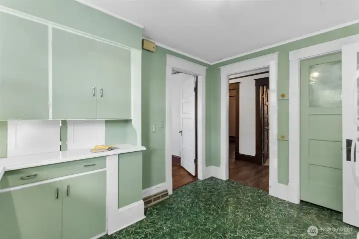 Left door is to the dining room, middle hallway to the bathroom, right door is the pantry/furnace location.