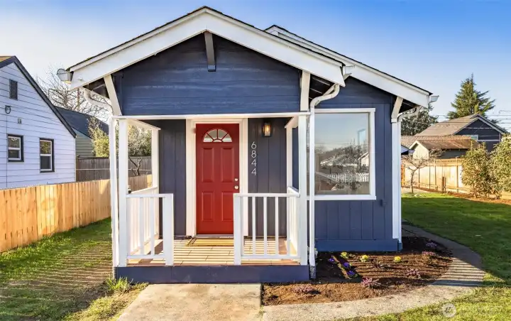 Freshly painted exterior with charming covered front porch and brand-new landscaping for standout curb appeal.