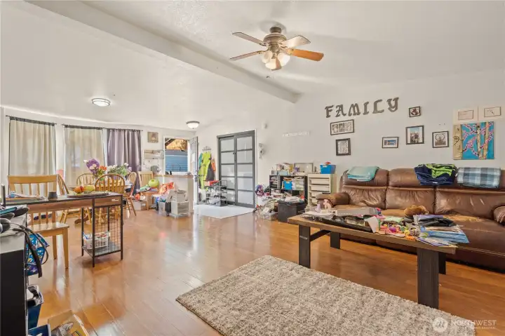View from Corner of Living Room facing Entry, Dining Room w/Bay Window. Barn Doors to Primary Suite.