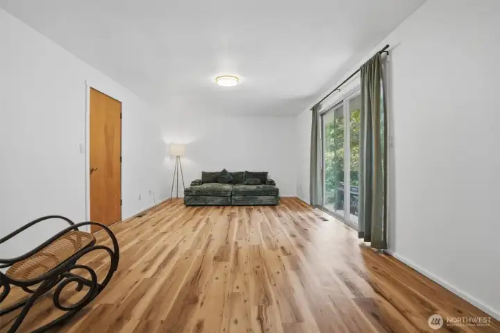Family room with access ot the garage and out back.