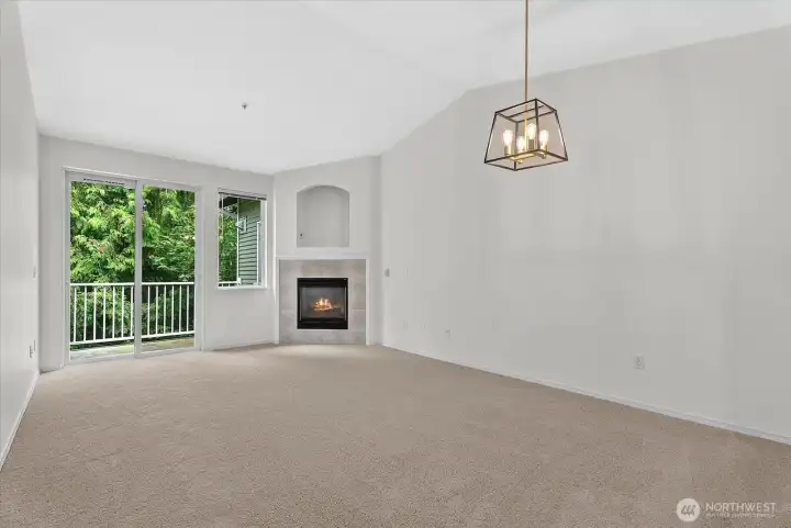 Living room with fireplace, private balcony and greenbelt view Living room with fireplace, private balcony and greenbelt view