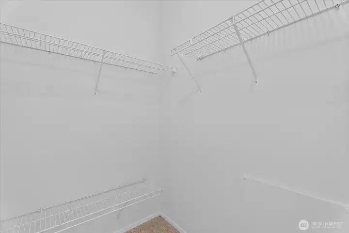 Primary bedroom walk-in closet Primary bedroom walk-in closet