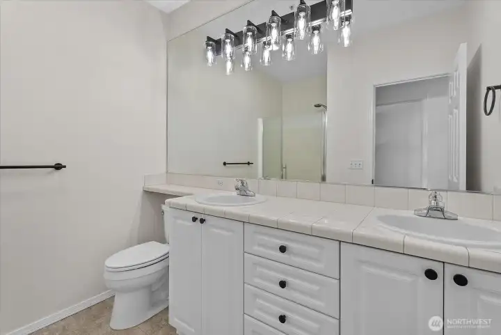 Primary en-suite bathroom with double vanity and shower Primary en-suite bathroom with double vanity and shower
