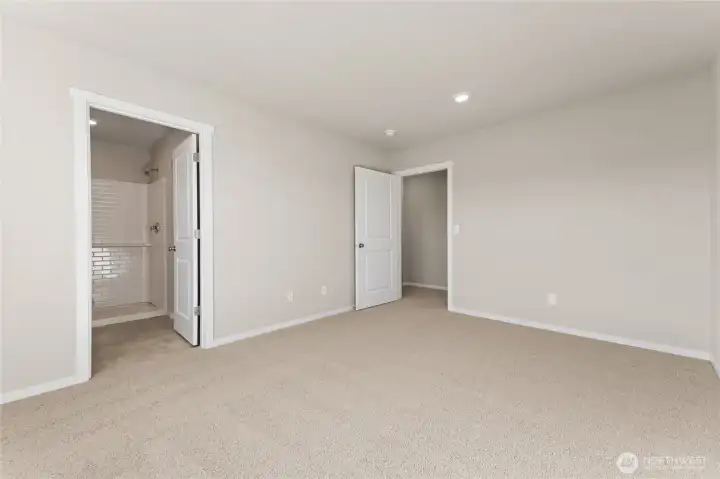 primary bedroom in to primary bath view.  photos are representative