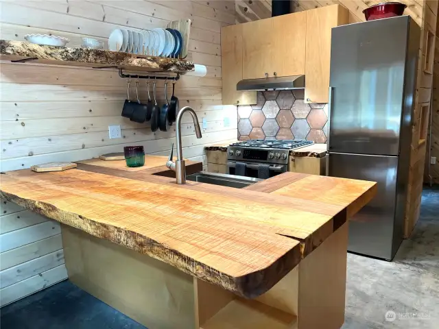 Live edge burl plate shelf compliments the highly figured countertops