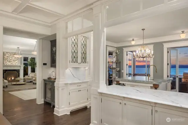 Natural flow between living, kitchen and dining. One can catch a glimpse of the built-in coffee station with its custom antique grey cabinetry.