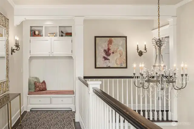 View of the upper landing with its built-in sitting area and cabinetry.