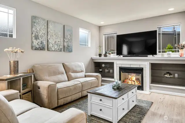 Cozy living room with a gas fireplace and plenty of natural light.