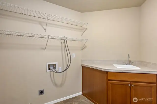 Next to the primary a space for laundry and the utility sink.
