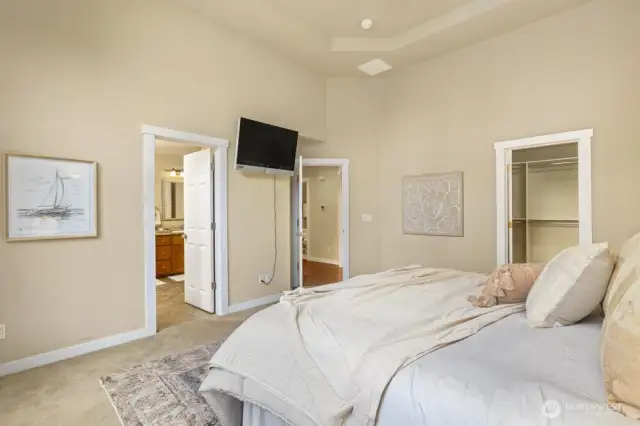 Door to primary bath, hallway, and walk-in closet.