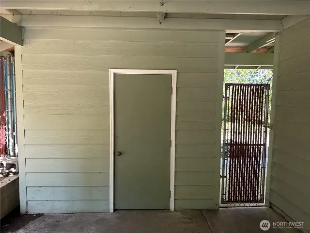 Storage shed in carport.