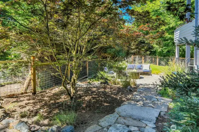 Stone walk way to fire pit in private back yard