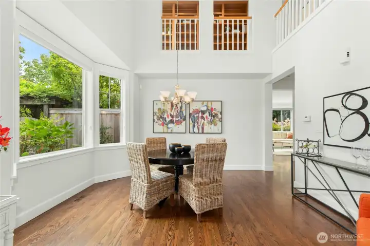 Formal dining room with a high ceiling and large windows