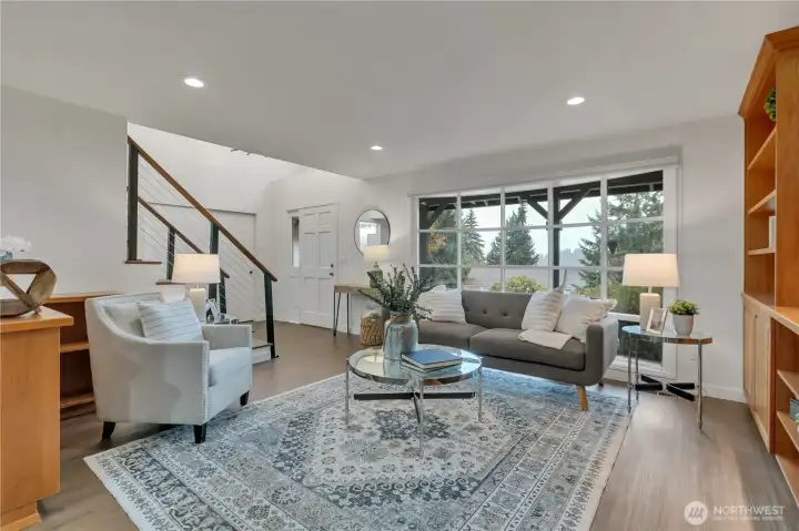 Wide picture window invites in warm, natural light.