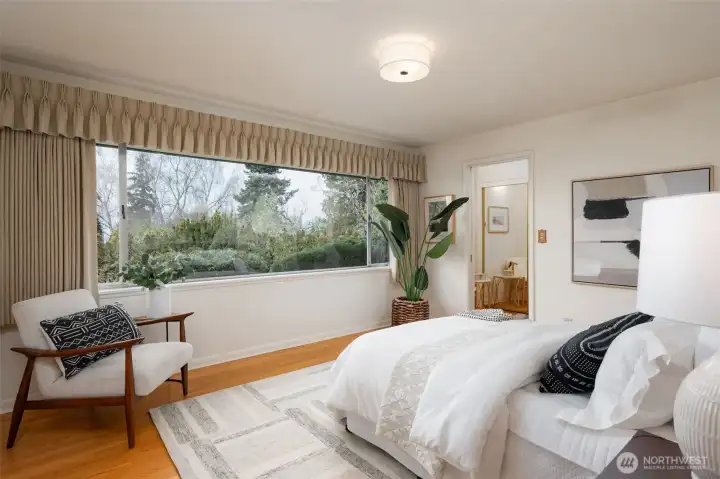Primary bedroom on main floor with adjacent walk-in closet and full bathroom.