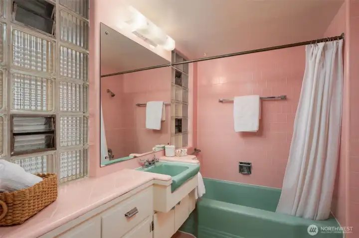 Main floor bathroom is a MCM delight with its original, refurbished tub and sink.  Tile is in excellent condition.