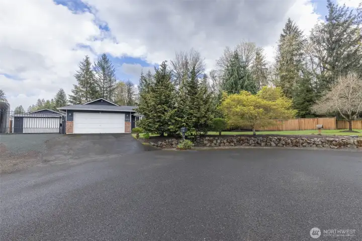 Front of the home with great curb appeal and a gated side yard entrance, offering added privacy and storage. Located in a cul-de-sac for a quiet, low-traffic setting.