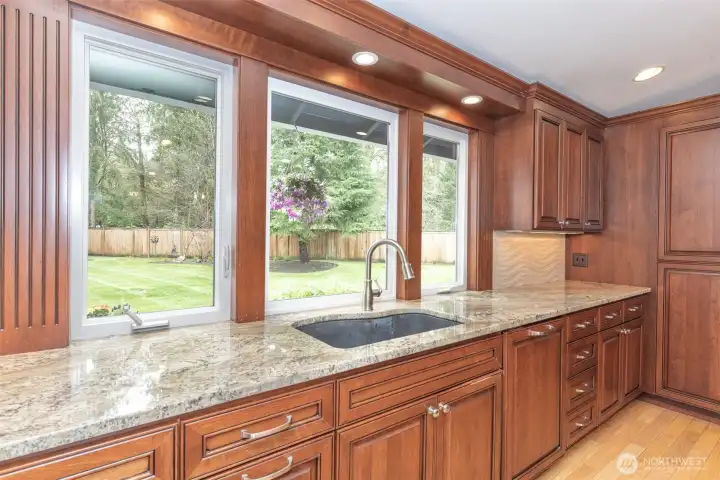Cabinet to the left of the sink features a built-in pull-out with trash containers.  Take a look while you tour the home.