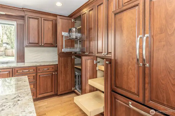 Kitchen detail showcasing convenient corner and cabinet roll-out organizers, providing easy access and maximizing storage efficiency.