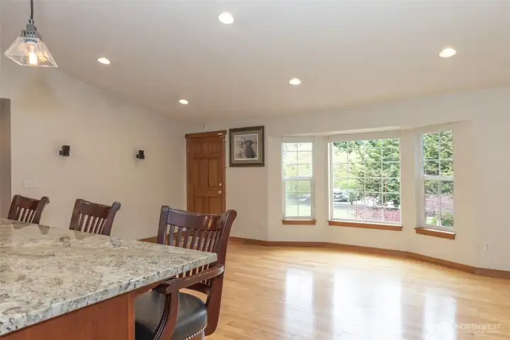 View from the kitchen looking toward the living room and front entry, showcasing the open-concept layout, and natural light.