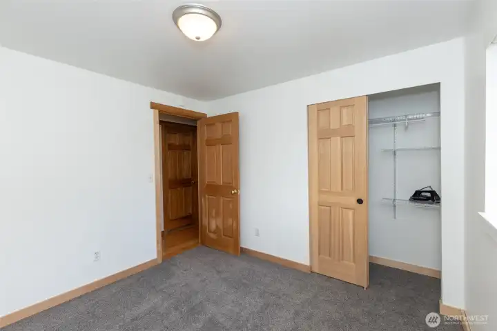 First bedroom on the right, featuring a built-in closet with organizers, providing efficient storage.