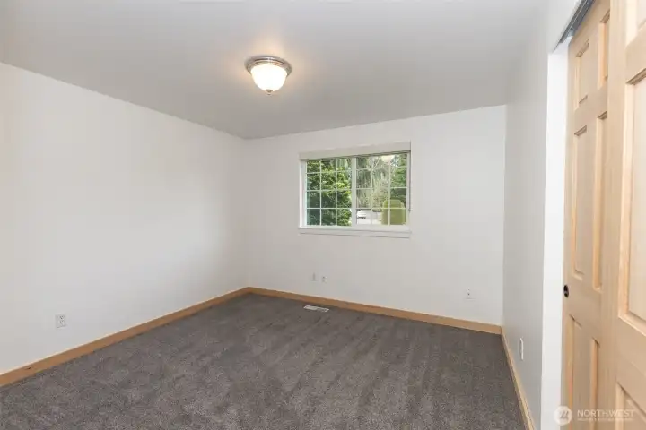 Second bedroom located at the end of the hallway, featuring a closet with organizers.