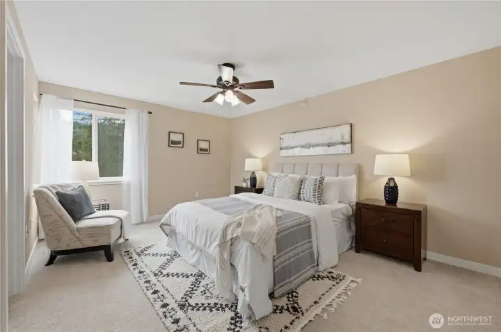 Primary bedroom with large closet and ceiling fan.