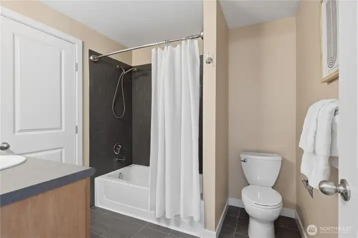 Continental bath with direct access to primary bedroom and hall.