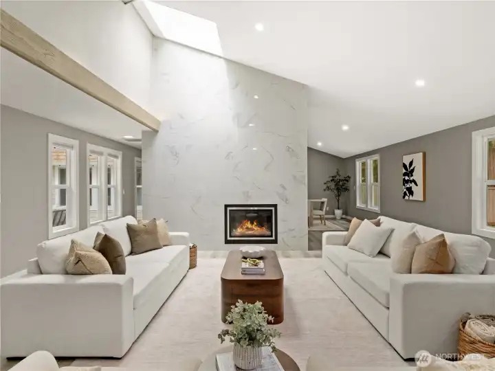 The double sided fireplace is the anchor of this incredible space, with living on one side, dining on the other. A hallway seamlessly connects the living and dining rooms with the outdoor atrium and kitchen.