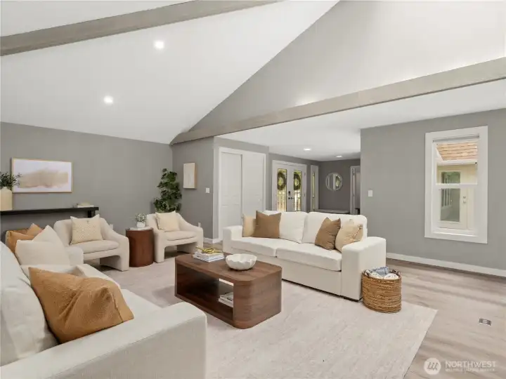 Dramatic vaulted ceilings with painted wood beams create volume and light.