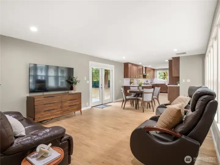 Light fills this area, with walls of windows to the atrium behind.